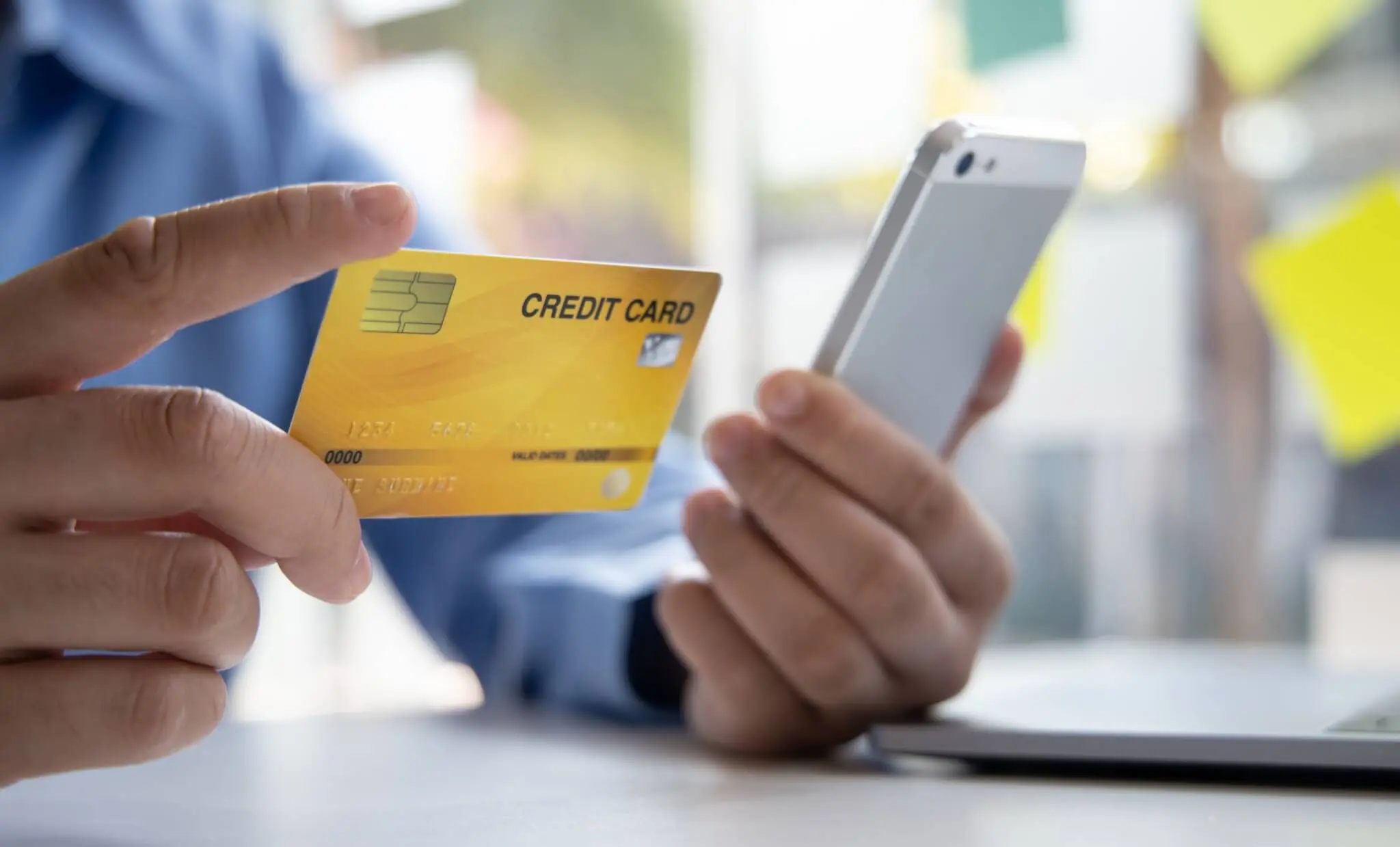 A fraud defense attorney examines a credit card and smartphone to investigate fraudulent activity