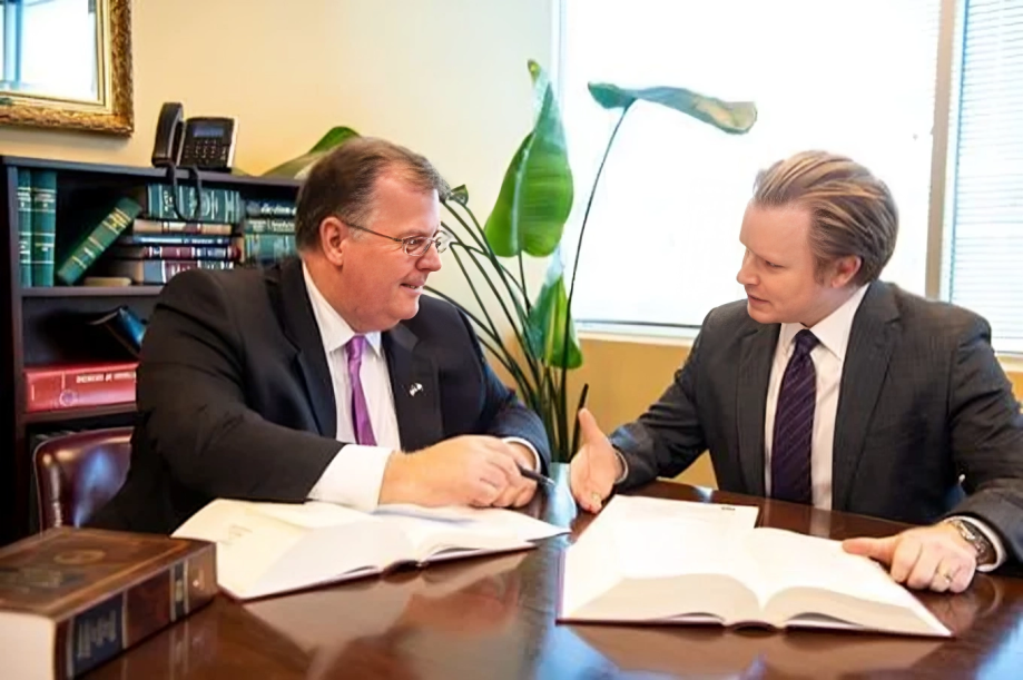 Scott C. Nolan at a table with legal files, in strategic discussion.