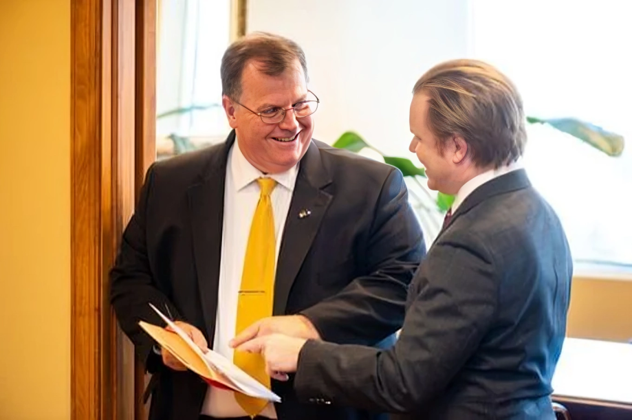 Attorney Scott C. Nolan in office with colleague, reviewing folder in discussion